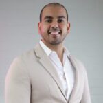 A man in a suit and white shirt