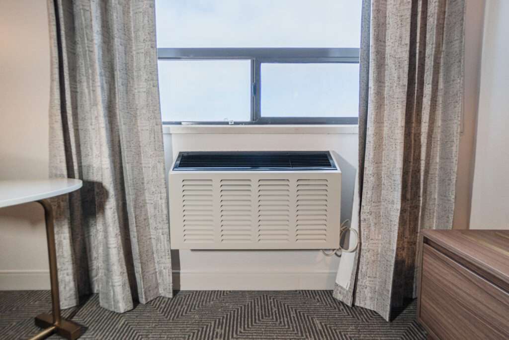 A window with curtains and blinds in front of it.- Canadian hotel room