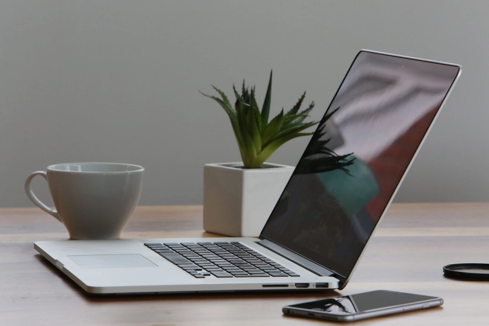 Laptop with coffee mug and phone